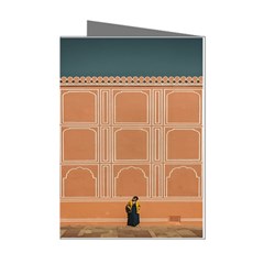 Person Stands By Tall Orange Wall And Looks Left